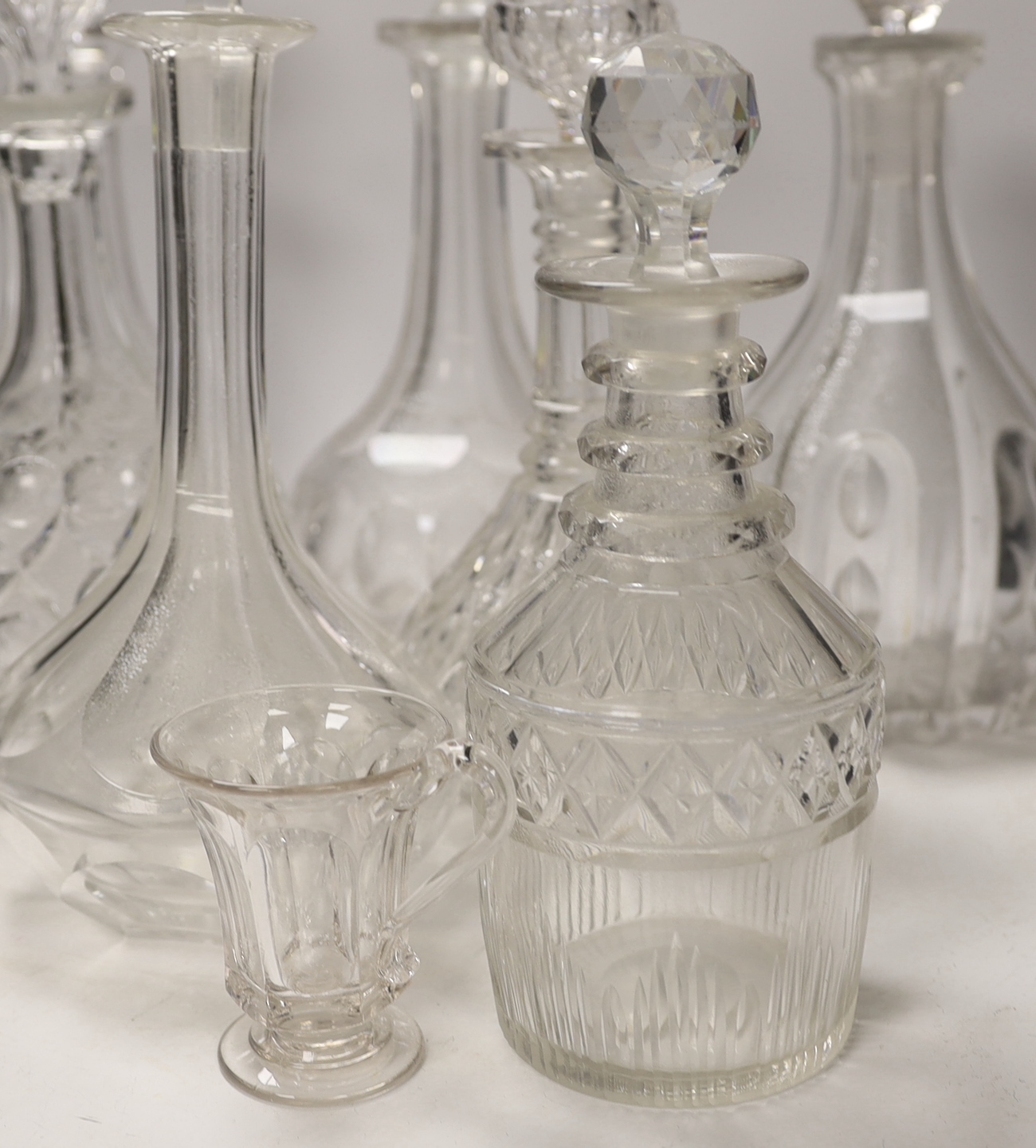 Seven decanters, all with stoppers, a carafe, a custard cup, tallest, decanter 34cm